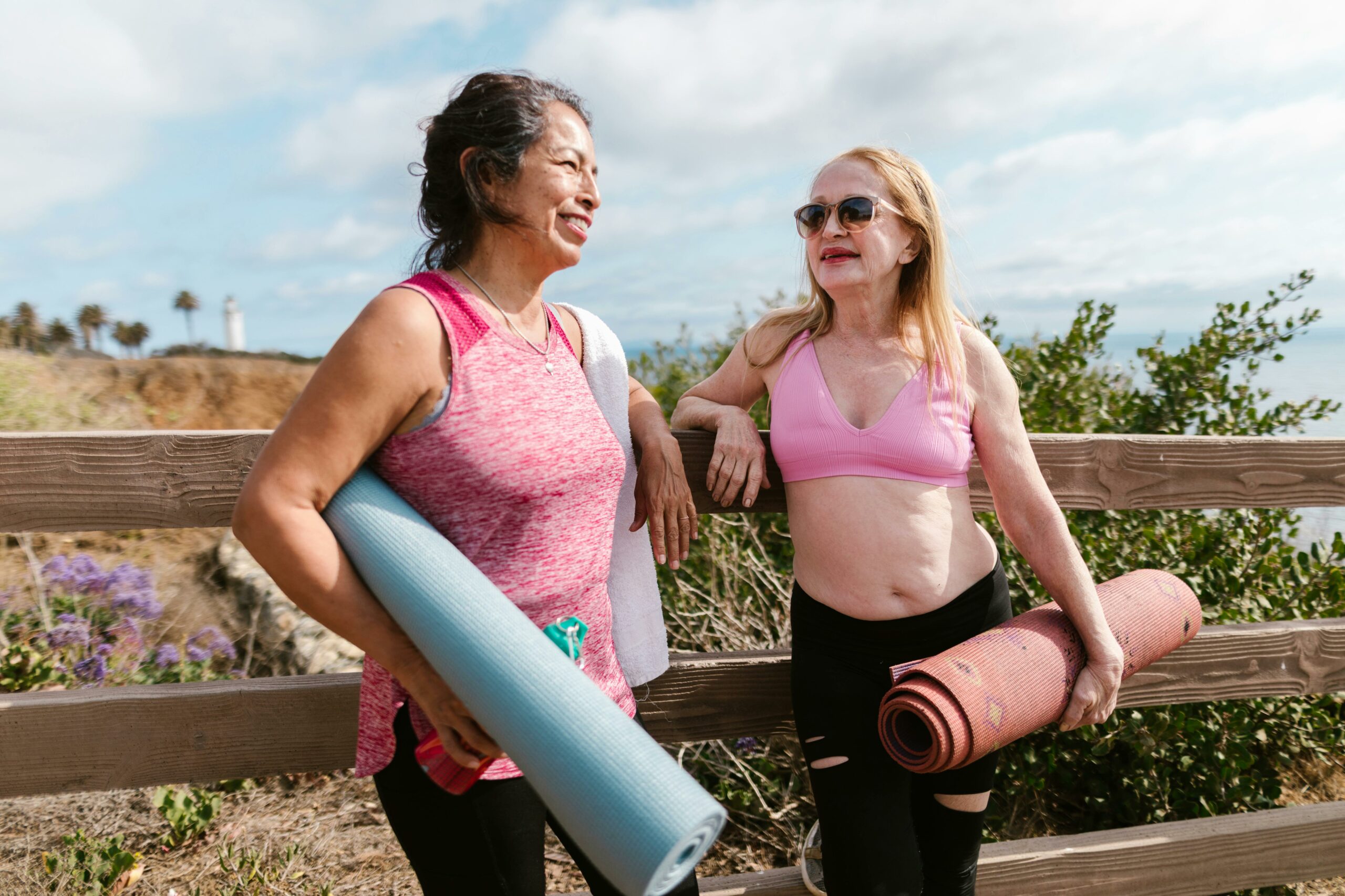 changing-bodies-two-women-talking-and-holding-yoga-mats