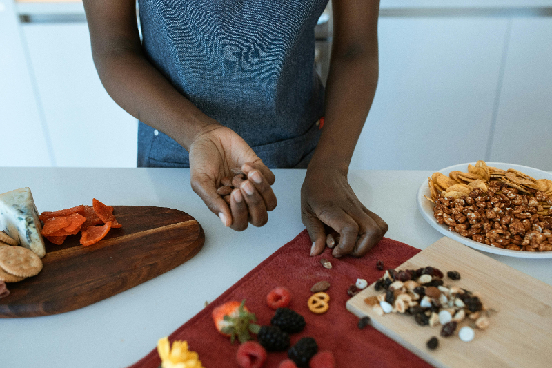 hands-setting-up-display-of-snacks